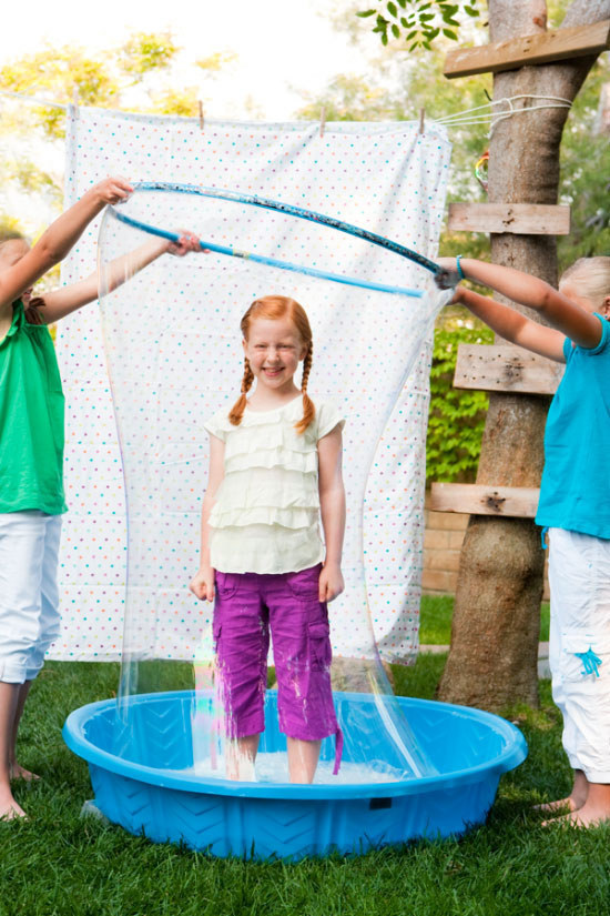 Use a hula hoop to make giant person-sized bubbles.