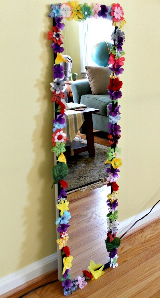 Spruce up an old mirror using fake flowers and a glue gun.